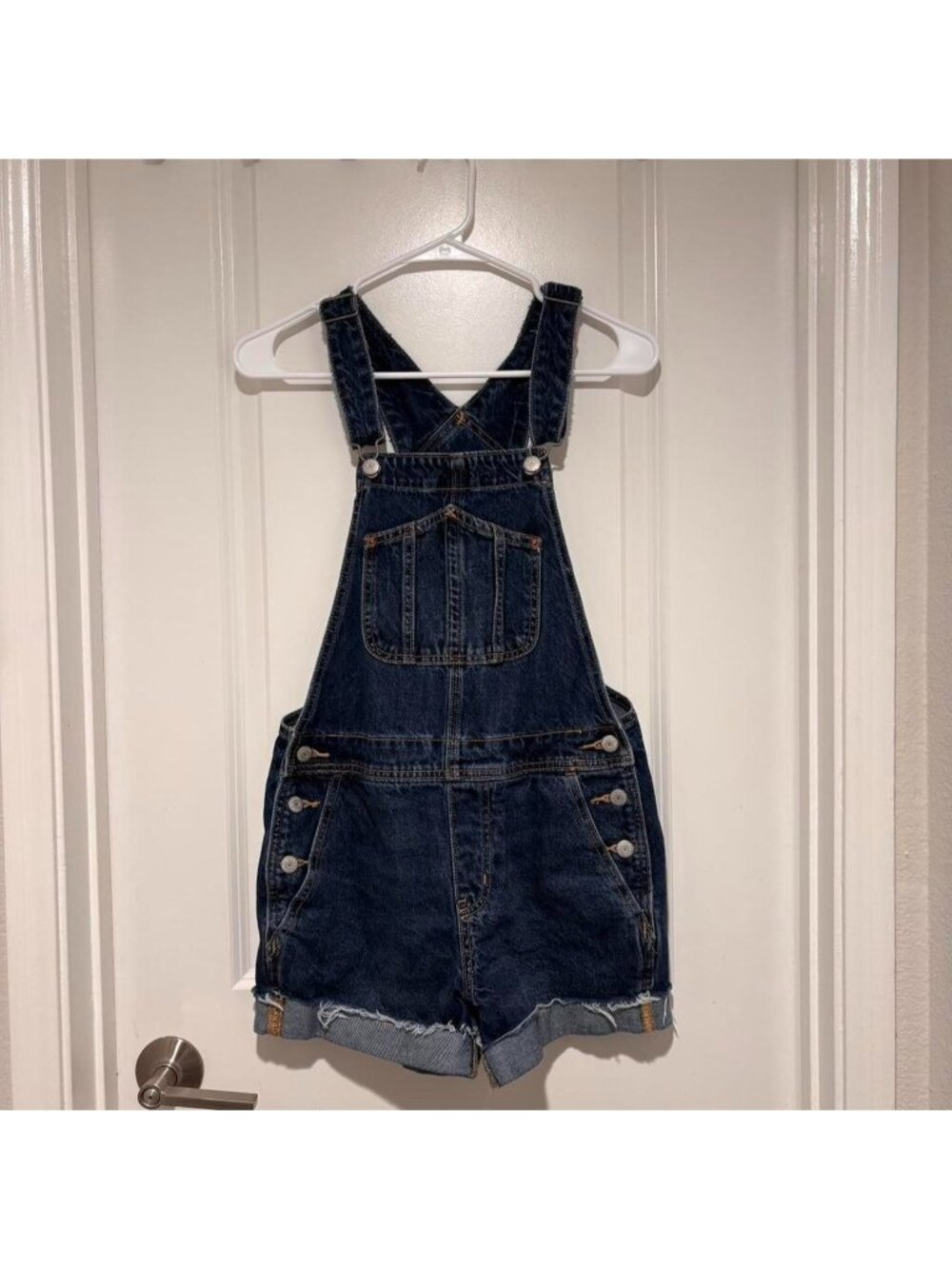 Old Navy blue denim overalls with adjustable straps and pockets.